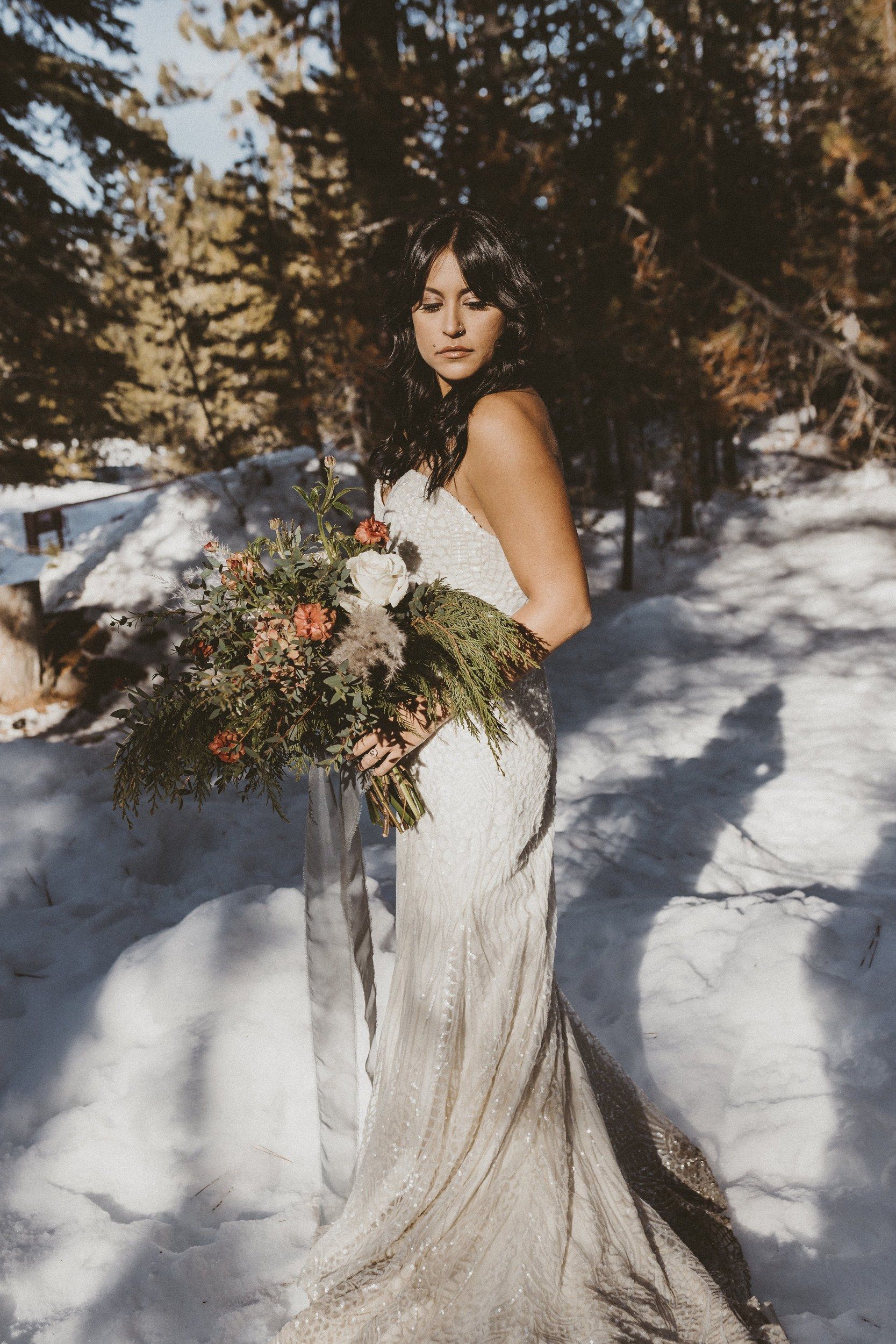 Bride with a bouquet in the snow, winter bridal hair