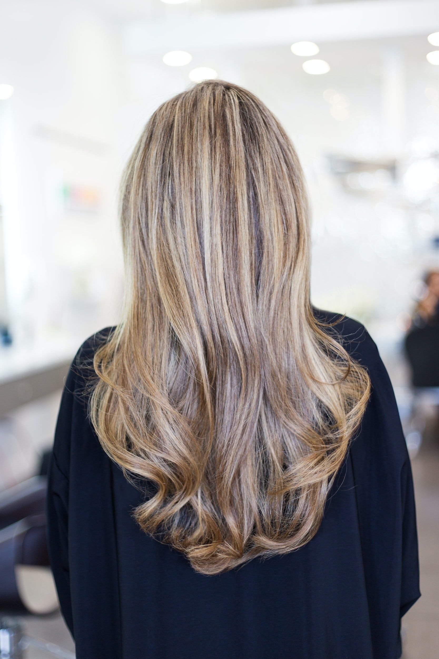 Long layered blonde hair from behind