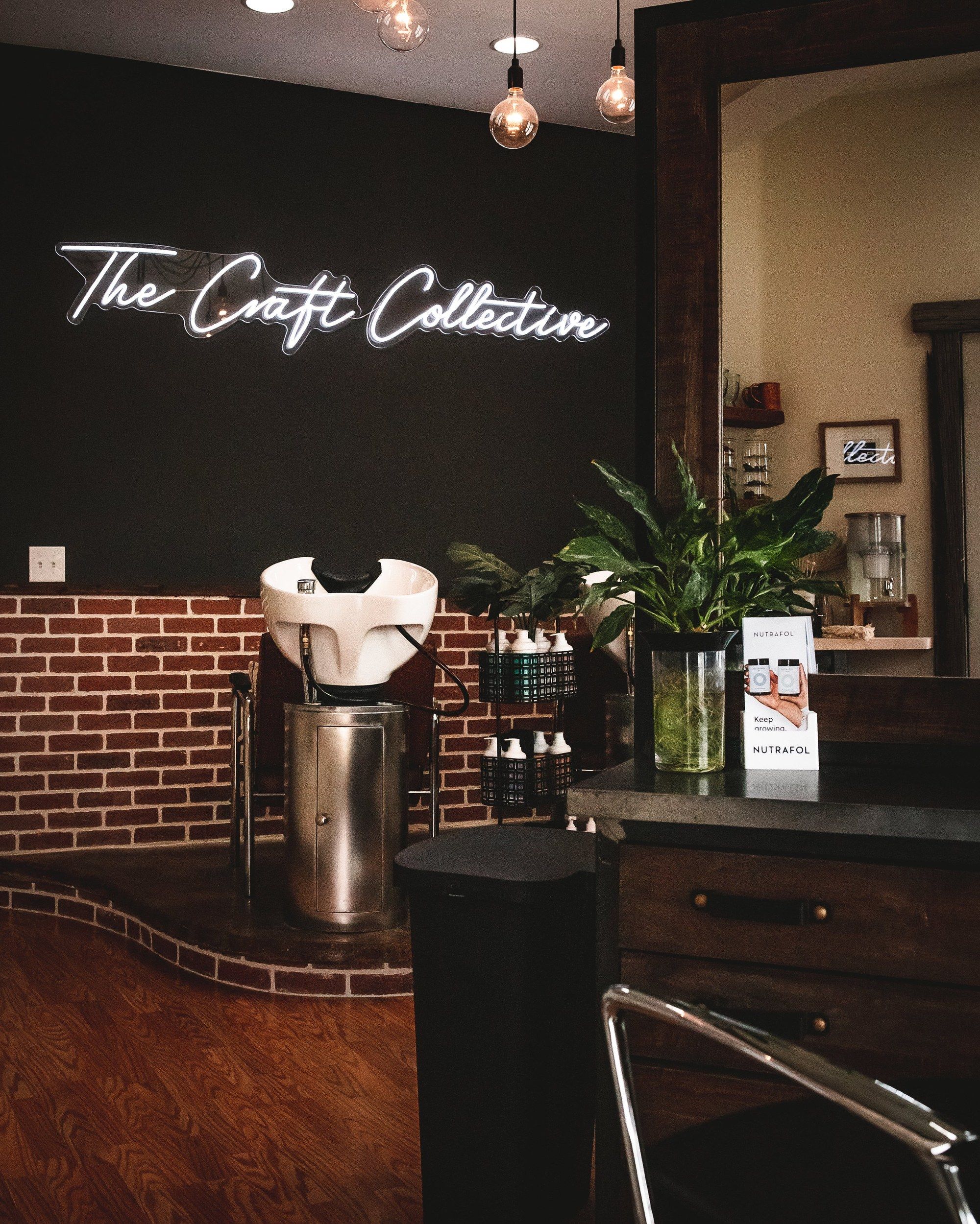 The Craft Collective salon with its neon sign and shampoo station