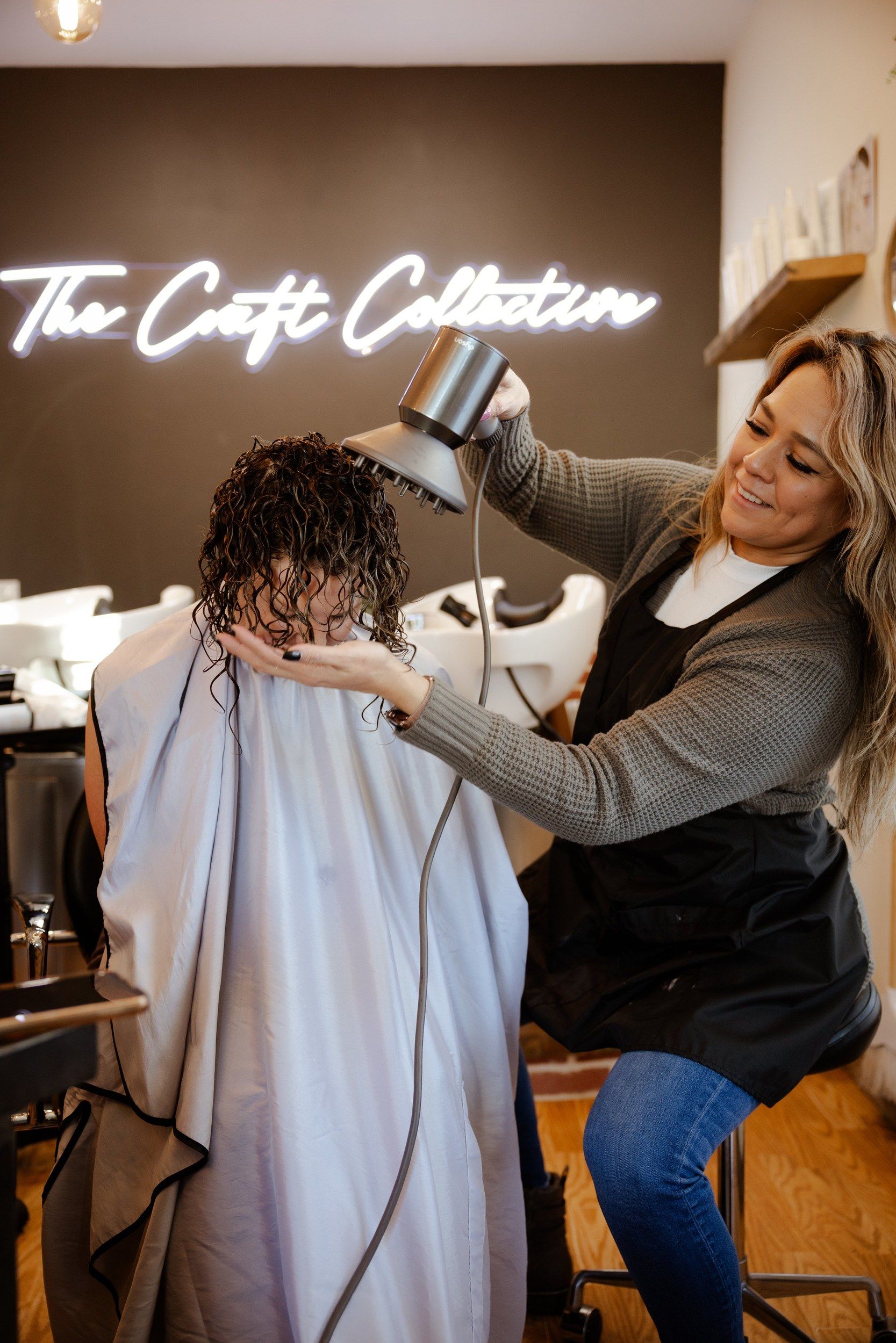 Stylist blow drying a client in the salon