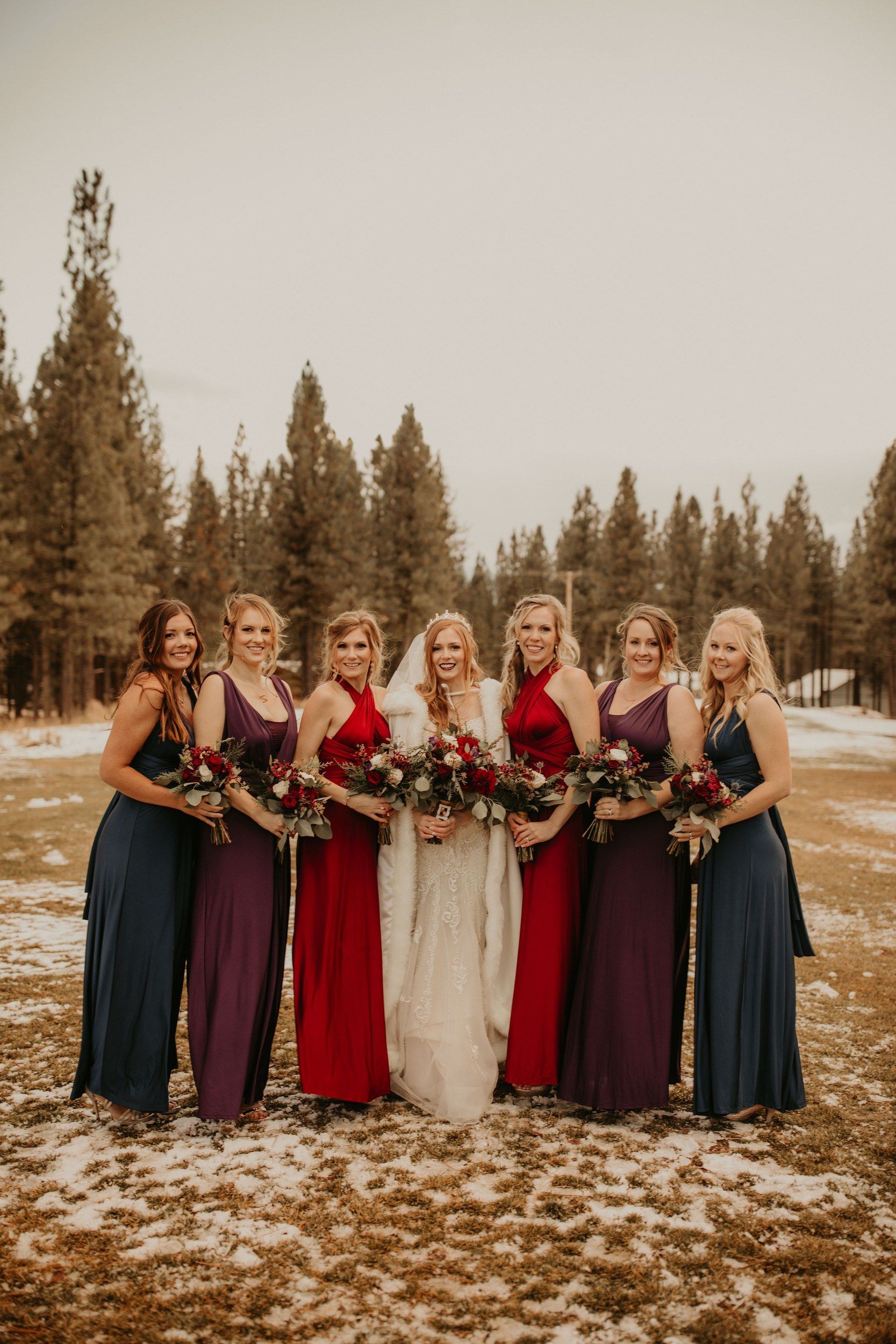 Bridal party in the snow with bouquets
