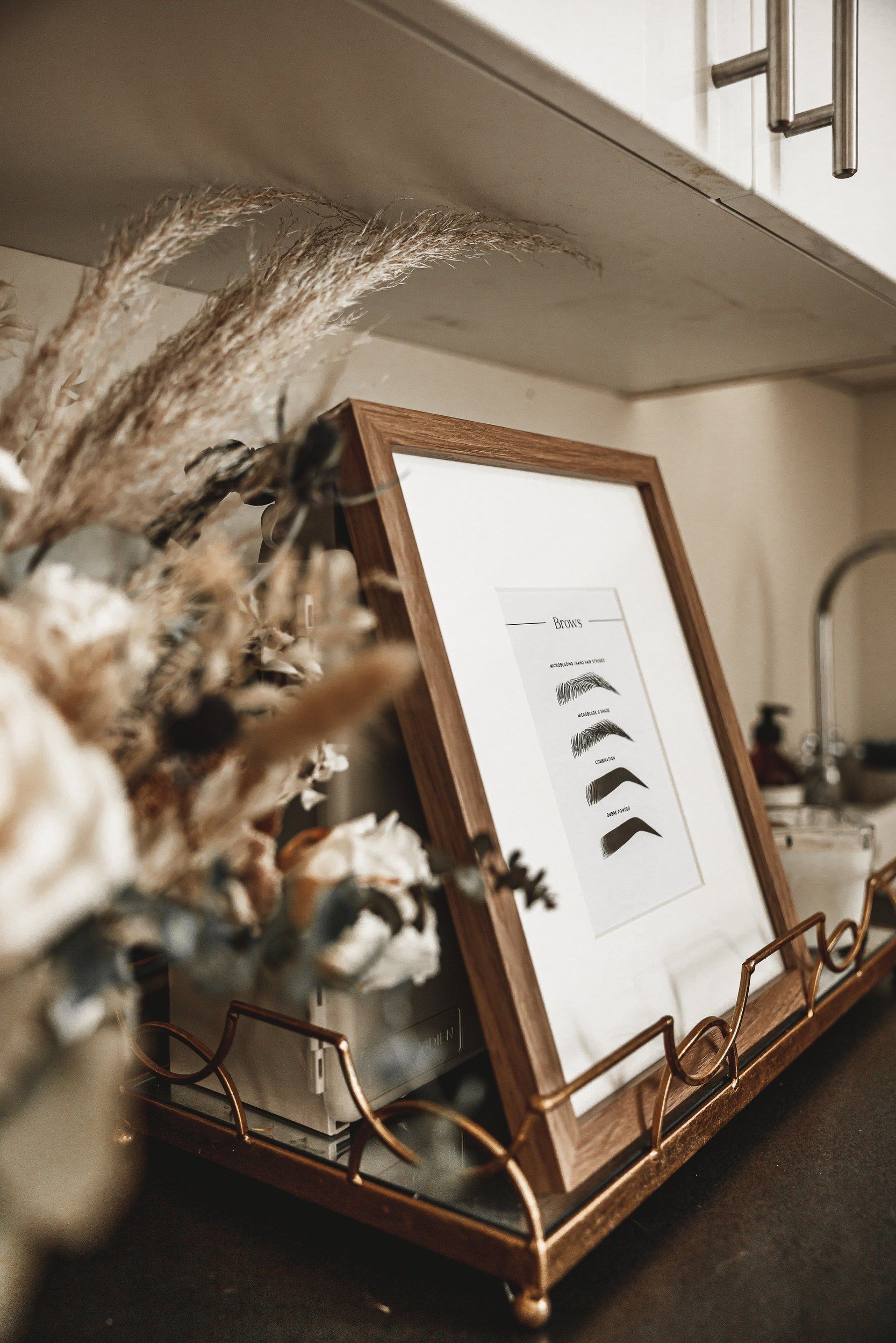 Framed artwork and dried flowers in the salon