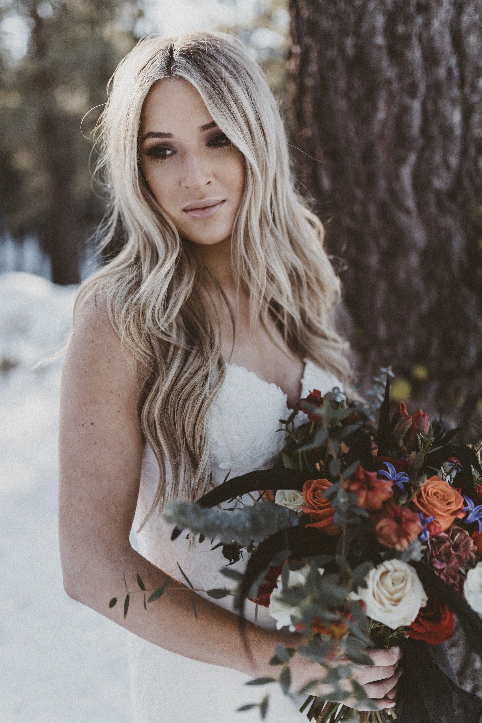 Bride with long blonde waves holding a bouquet